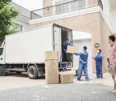 depositphotos_36659147-stock-photo-couple-watching-movers-move-boxes